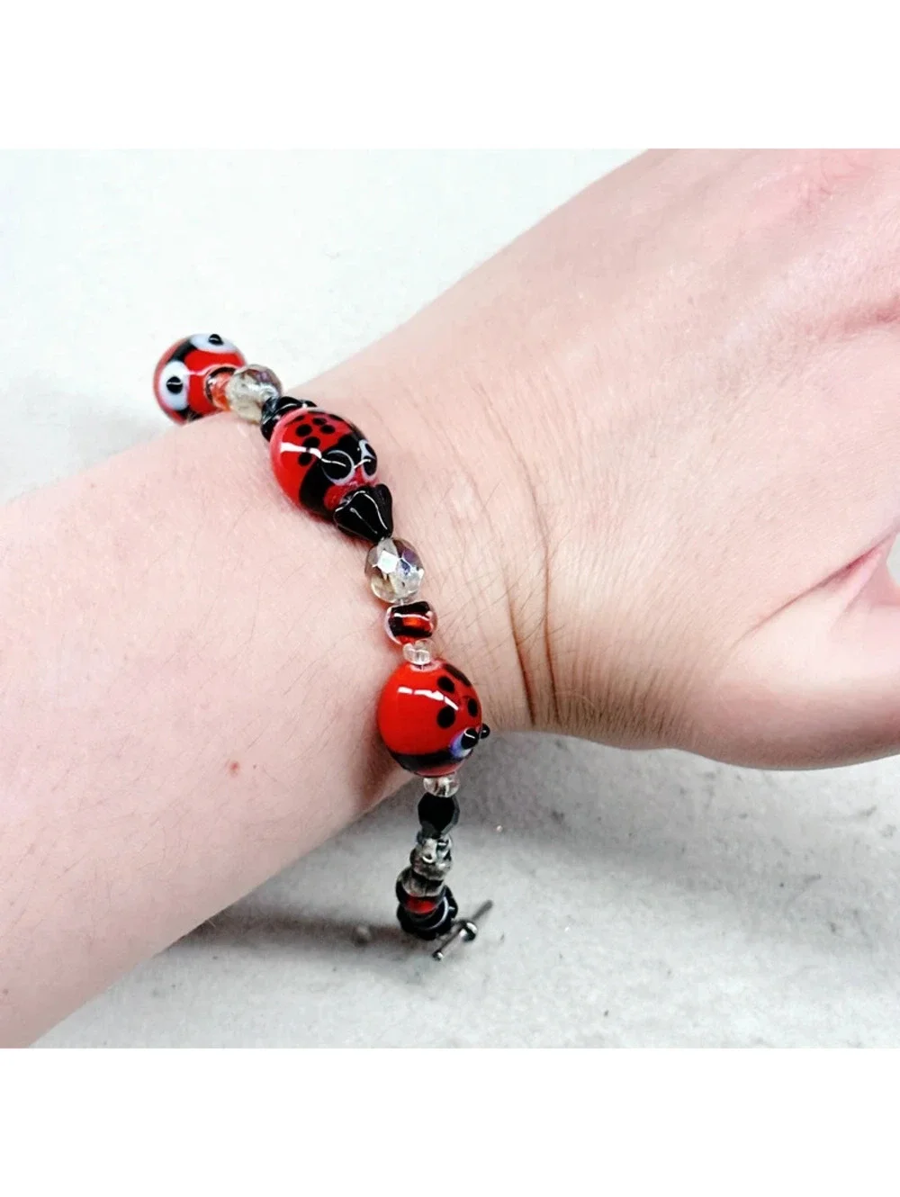 3011u. Silly Ladybug Glass Bracelet Silvertone